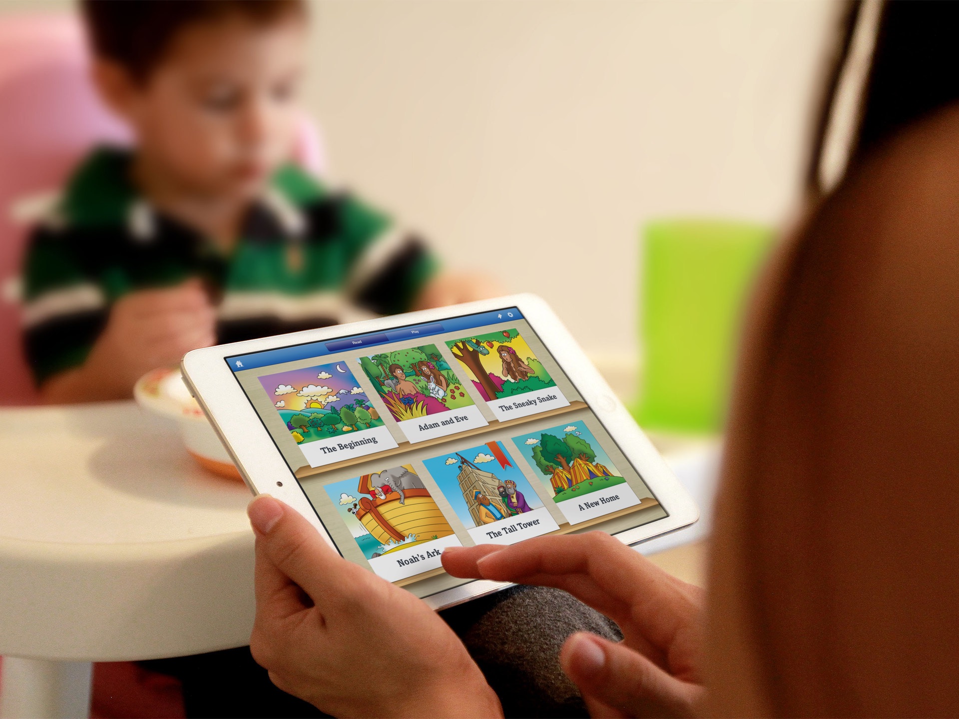 The Beginner’s Bible illustrated story selection displayed on an iPad held by a reader.
